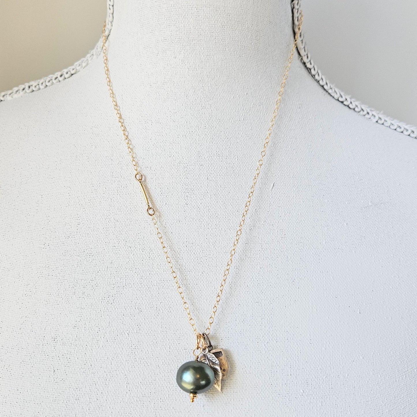 Gold and pearl charm